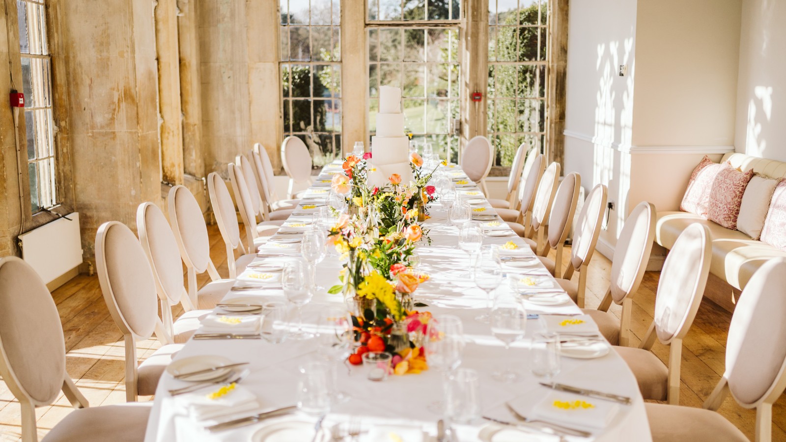 floral garden wedding, a contemporary white iced cake with colourful summer florals luxury wedding cake surrey