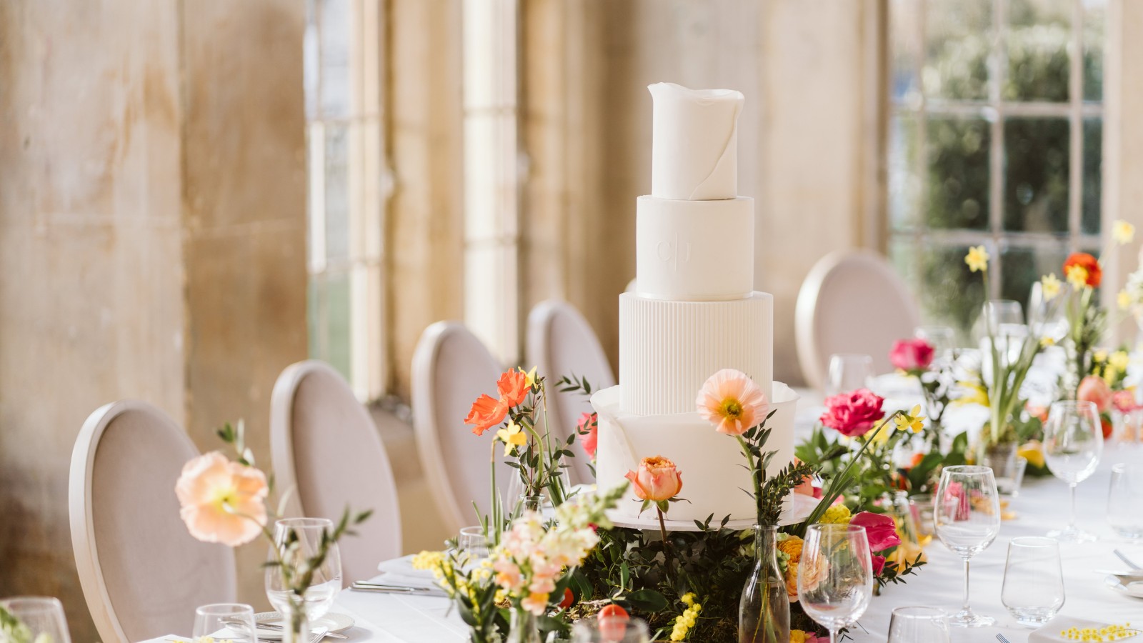 floral garden wedding, a contemporary white iced cake with colourful summer florals luxury wedding cake surrey